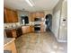 Bright kitchen with stainless appliances, wood cabinetry, and tile flooring at 4254 Wood Cove Dr, Snellville, GA 30039