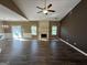 Open living room featuring a fireplace, abundant natural light, and modern ceiling fan at 4254 Wood Cove Dr, Snellville, GA 30039