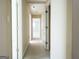 Hallway with doors, showing access to other rooms and natural light coming through at 30 Hickory Dr, Stockbridge, GA 30281