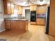 Well-lit kitchen with custom cabinets, stainless steel appliances, and hardwood floors at 30 Hickory Dr, Stockbridge, GA 30281