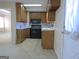 Standard kitchen with wooden cabinets, black appliances and tile floor at 30 Hickory Dr, Stockbridge, GA 30281