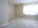 Bright living room featuring carpeted floors, natural light, and neutral paint at 30 Hickory Dr, Stockbridge, GA 30281