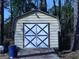 Exterior of a storage shed with white doors, siding and a small ramp to the door at 30 Hickory Dr, Stockbridge, GA 30281