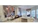 Bright eat-in kitchen features granite countertops, stainless steel appliances, and natural light at 725 White Dove Dr, Mcdonough, GA 30253