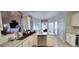 Modern kitchen with white cabinets, granite countertops, stainless steel appliances, and ample natural light at 725 White Dove Dr, Mcdonough, GA 30253