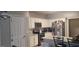 Well-lit kitchen boasts stainless appliances, marble countertops, and white cabinets at 725 White Dove Dr, Mcdonough, GA 30253