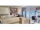 Modern kitchen with white cabinets, granite countertops, stainless steel appliances, and ample natural light at 725 White Dove Dr, Mcdonough, GA 30253