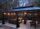 Evening shot of a covered patio with a heater and string lights, ideal for outdoor gatherings at 725 White Dove Dr, Mcdonough, GA 30253