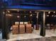 Nighttime view of a covered patio equipped with outdoor lighting, a heater, and plenty of seating at 725 White Dove Dr, Mcdonough, GA 30253