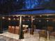 Well-lit, covered patio at night with string lights, a heater, and comfortable seating at 725 White Dove Dr, Mcdonough, GA 30253