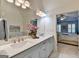 Bathroom with double vanity, quartz countertop and view of bedroom with plantation shutters at 7920 Willoughby Ct, Alpharetta, GA 30005