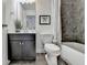 Bathroom with dark vanity, tub and shower with tiled walls at 7920 Willoughby Ct, Alpharetta, GA 30005