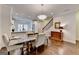 View of open dining room with wood floors, marble table and staircase in background at 7920 Willoughby Ct, Alpharetta, GA 30005