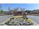 Welcoming Jamestown entrance featuring manicured flower beds and brick signage, indicating a vibrant community at 7920 Willoughby Ct, Alpharetta, GA 30005