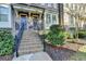 Charming townhouse with brick facade, front steps and manicured landscaping at 7920 Willoughby Ct, Alpharetta, GA 30005