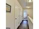 Upstairs hallway with hardwood floors and white doors leading to bedrooms at 7920 Willoughby Ct, Alpharetta, GA 30005