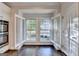 Bright kitchen nook with natural light, hardwood floors, and white cabinetry at 7920 Willoughby Ct, Alpharetta, GA 30005