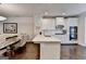 Bright kitchen featuring white cabinets, a large island, and stainless steel appliances at 7920 Willoughby Ct, Alpharetta, GA 30005
