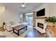 Cozy living room with a fireplace, hardwood floors, and access to the outdoor patio at 7920 Willoughby Ct, Alpharetta, GA 30005