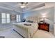 Serene bedroom with tray ceilings, plush carpeting, and two large shuttered windows at 7920 Willoughby Ct, Alpharetta, GA 30005