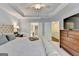 Spacious bedroom with tray ceilings, a ceiling fan, and plush carpeting at 7920 Willoughby Ct, Alpharetta, GA 30005