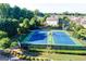 Aerial view of community tennis courts surrounded by trees and neighborhood homes at 7920 Willoughby Ct, Alpharetta, GA 30005