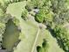 Aerial shot showcases a pond nestled on acreage with mature trees and a long driveway leading to the home at 115 Ebenezer Church Rd, Fayetteville, GA 30215