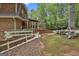 Exterior view of the backyard featuring a quaint white fence and lush landscaping at 115 Ebenezer Church Rd, Fayetteville, GA 30215