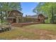 Spacious backyard featuring a large deck, ideal for outdoor entertaining and relaxation, with mature trees at 115 Ebenezer Church Rd, Fayetteville, GA 30215