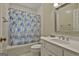 Cozy bathroom featuring a shower/tub combination with a patterned curtain and a vanity sink at 115 Ebenezer Church Rd, Fayetteville, GA 30215