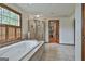 Bright bathroom with a soaking tub under a window and a glass enclosed shower at 115 Ebenezer Church Rd, Fayetteville, GA 30215