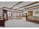 Large bedroom with beamed ceilings, multiple windows, and carpeted flooring at 115 Ebenezer Church Rd, Fayetteville, GA 30215