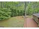 Exterior shot of a deck surrounded by green trees, featuring an inviting outdoor living space at 115 Ebenezer Church Rd, Fayetteville, GA 30215
