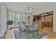 Bright dining area featuring a glass table, stylish chairs, and large windows with a wooded view at 115 Ebenezer Church Rd, Fayetteville, GA 30215