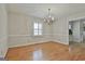 Bright dining room featuring hardwood floors, classic chandelier, and ample natural light from the window at 115 Ebenezer Church Rd, Fayetteville, GA 30215