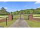 Long driveway with black wrought iron gate leads to home at 115 Ebenezer Church Rd, Fayetteville, GA 30215