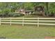 Charming home with detailed landscaping, accessed by a white picket fence at 115 Ebenezer Church Rd, Fayetteville, GA 30215