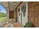 Welcoming front porch with double doors, stylish tile flooring, and decorative plants, exuding charm and warmth at 115 Ebenezer Church Rd, Fayetteville, GA 30215