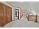 Open upstairs hallway featuring carpeting and views of other rooms, leading to a cozy atmosphere at 115 Ebenezer Church Rd, Fayetteville, GA 30215