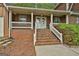 Inviting home exterior featuring a brick staircase leading to a covered porch at 115 Ebenezer Church Rd, Fayetteville, GA 30215