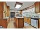 Spacious kitchen boasts wood cabinetry, granite island, and modern appliances with lots of natural light at 115 Ebenezer Church Rd, Fayetteville, GA 30215