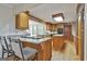Traditional kitchen featuring wood cabinets, granite countertops and a bar area for gathering at 115 Ebenezer Church Rd, Fayetteville, GA 30215