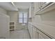 Well-lit laundry room with tiled floors, ample cabinet space, and a large window for natural light at 115 Ebenezer Church Rd, Fayetteville, GA 30215