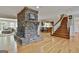 Bright and airy living room with hardwood floors, fireplace, and an open layout to kitchen at 115 Ebenezer Church Rd, Fayetteville, GA 30215