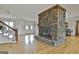 Spacious living room with a stone fireplace, hardwood floors, and views of the entryway at 115 Ebenezer Church Rd, Fayetteville, GA 30215