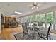 Open-concept living room featuring a glass dining table and light-filled space, perfect for entertaining at 115 Ebenezer Church Rd, Fayetteville, GA 30215