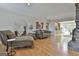 Cozy living room with hardwood floors, comfortable seating, and views of the backyard and stone fireplace at 115 Ebenezer Church Rd, Fayetteville, GA 30215