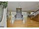 Open living room with stone fireplace, hardwood floors, and abundant natural light at 115 Ebenezer Church Rd, Fayetteville, GA 30215
