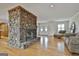 Inviting living room boasts a stone fireplace, hardwood floors, and ample natural light at 115 Ebenezer Church Rd, Fayetteville, GA 30215