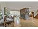 Spacious living room with stone fireplace, hardwood floors, and an open layout to the kitchen at 115 Ebenezer Church Rd, Fayetteville, GA 30215